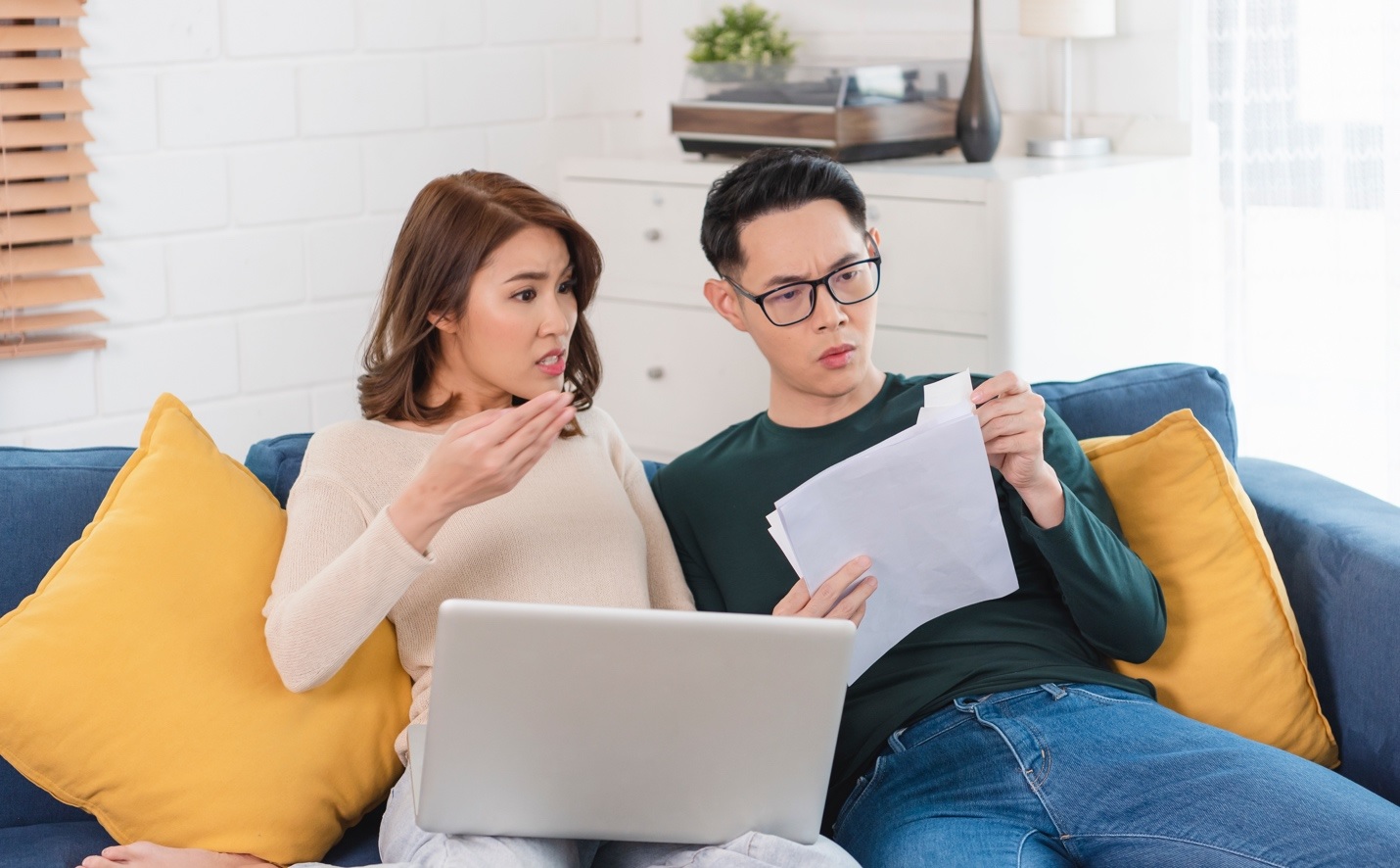 man,woman,reading,papers,shocked